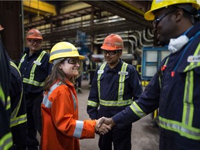 Canadian Foreign Affairs Minister Chrystia Freeland shakes hands with employees at the Evraz steel plant in Regina on May 22, 2019.