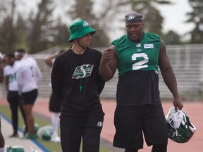 Micah Johnson (right) chats with special teams assistant Mike Scheper after practice at Griffiths Stadium in Saskatoon on May 23, 2019.