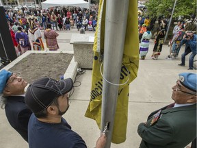 Steven Ross, left to right, Cris Figueroa, and Emile Highway raise the reconciliation flag during the 4th Annual Reconciliation Saskatoon Flag Raising Ceremony at City Hall in Saskatoon, SK on Friday, May 24, 2019.