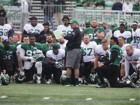 Riders head coach Craig Dickenson (centre) addressed the team after Saturday's Green and White scrimmage.