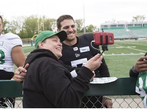 Quarterback Cody Fajardo, shown here taking a selfie with Riders fan Cheryl Wrishko, was all smiles after a strong showing in the Roughriders' Green and White game.