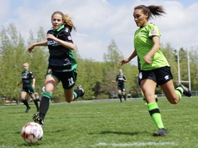 Damiane Sawatzky, left, of Calgary Foothills and Taneil Gay of QC United chase a loose ball during United Women's Soccer action Sunday at Regina Rugby Park.