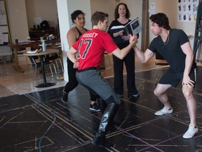 Cast members of Beauty and the Beast Josh Doig, centre left, and Alex Kelly, right, rehearse a scene for the upcoming production at the Globe Theatre. Pictured at centre right is director Stephanie Graham.