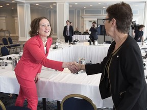 Minister of Energy and Resources Bronwyn Eyre, left, is greeted by Senator Beverly Busson before she addresses a Senate hearing on Bill C-48 held at the Hotel Saskatchewan in Regina.