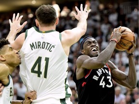 Milwaukee Bucks forward Nikola Mirotic (41) defends as Toronto Raptors forward Pascal Siakam (43) is fouled on the way to the net during second half NBA Eastern Conference finals playoff basketball action in Milwaukee on Wednesday, May 15, 2019.