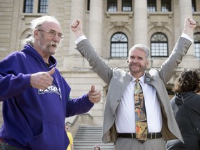 Jim Elliott, from left, one of the Council of Canadians, who is one of the intervenors represented by Kowalchuk, Larry Kowalchuk, the lawyer representing a coalition of 10 intervenors on behalf of the federal government react to wining the Court of Appeal for Saskatchewan on the carbon tax court case in Regina.