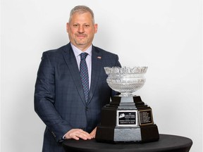 Prince Albert Raiders general manager Curtis Hunt is shown with the Lloyd Saunders Memorial Trophy, which goes to the Western Hockey League's coach of the year, on Wednesday.