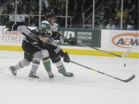 The Prince Albert Raiders' Aliaksei battles for the puck with Vancouver Giants' defenceman Seth Bafaro during Game 6 of their Western Hockey League championshop series Sunday night in Prince Albert. (Peter Lozinski/Prince Albert Daily Herald)