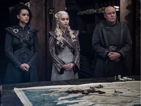 This image released by HBO shows Nathalie Emmanuel, Emilia Clarke, Conleth Hill in a scene from "Game of Thrones," that aired Sunday, May 5, 2019. "Game of Thrones" fans got a taste of the modern world as the fictional series winds down to its final episodes. Eagle-eyed viewers Sunday spotted a takeout coffee cup on the table during a celebration in which the actors drank from goblets and horns. Daenerys and Jon did not react to the out of place cup.
