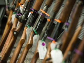 Long guns, collected by the Regina Police Service in its 2019 gun amnesty program, sit against a table at police headquarters on Osler Street.