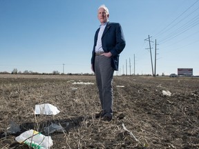 Regina city councillor Bob Hawkins stands in a farmer's field just east of Fleet Street, which is full of refuse including disposable plastic grocery bags. Hawkins' motion to ban the bags sailed through council on Wednesday.
