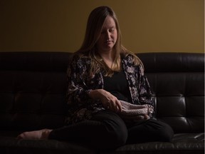 Jennifer McKnight, coordinator for the Twinkle Star Project, sits in her Regina home holding one of the hand-made baskets that her organization makes for bereaved parents. She herself lost three pregnancies.