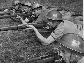 Marksmen of the Canadian Scottish Regiment set their sights on the targets ahead during rifle practice in England in 1943. (Canadian Army photo)