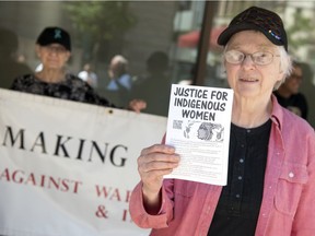 Florence Stratton, local social rights and peace activist, holds up a pamphlet at the Making Peace Vigil, which has been conducted at the Frederick W. Hill Mall on Scarth Street in Regina every Thursday at noon for 12 years.