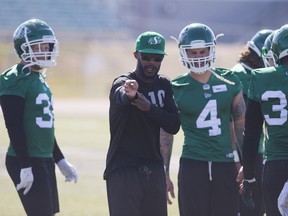 Saskatchewan Roughriders defensive co-ordinator Jason Shivers (centre) coaches linebackers Sam Hurl and Cameron Judge (4) during the Riders' training camp in Saskatoon.