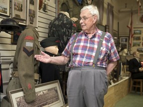 Keith Inches, curator of the Saskatchewan Military Museum at the Regina Armoury, stands with a display commemorating the Royal Regina Riles' role in the storming of the beaches of Normandy on June 6, 1944.