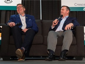 Saskatchewan Premier Scott Moe, left, laughs at a joke made by Alberta Premier Jason Kenney during the Saskatchewan Oil & Gas Show held at the Crescent Pointe Centre in Weyburn.