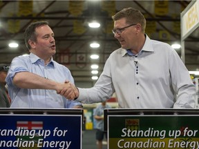 Saskatchewan Premier Scott Moe, right, shakes hands with Alberta Premier Jason Kenney during the Saskatchewan Oil & Gas Show in Weyburn, prior to the COVID-19 pandemic.