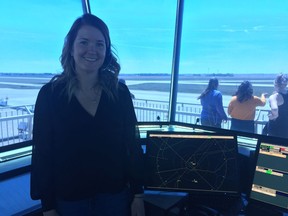 Jaclyn Cleug, an air traffic controller for Nav Canada at the Regina International Airport, stands in the airport's air traffic control tower.
