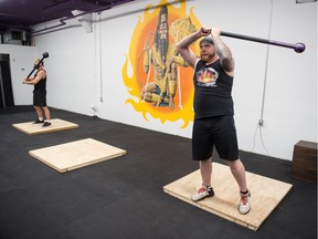 Sacha Wolfson of Regina, right, and Adam Stewart of Regina compete at the Warrior Flow second annual steel mace competition at the gym's Dewdney Avenue location.