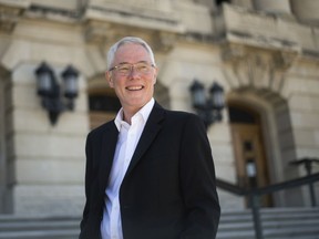 Arnold McKenzie, a recently retired tour guide at the Saskatchewan Legislative Building, stands outside his former place of employment in Regina.