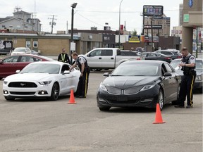 Members of the Regina Police Service, RCMP, Moose Jaw Police Service and Saskatchewan Highway Patrol take part in a combined traffic enforcement project in Regina on Wednesday. There were several locations Tuesday and Wednesday, including this on the 1300 block of Albert Street.