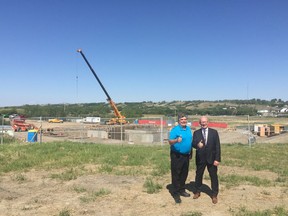 Lumsden mayor Bryan Matheson and provincial minister of government relations Warren Kaeding stand in construction for the Town of Lumsden's new wastewater treatment facility.