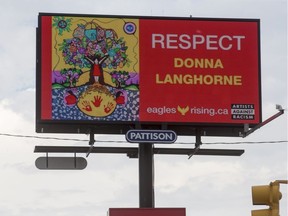 A billboard with art by Donna Langhorne, which is part of a national Artists Against Racism campaign to raise awareness for Missing and Murdered Indigenous Women and Girls in Canada, stands near the intersection of dylwyld Drive North and 23rd Street in Saskatoon, SK on Wednesday, June 19, 2019.