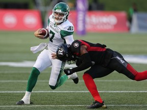 Saskatchewan Roughriders quarterback Cody Fajardo, left, threw for 360 yards in his first CFL start on Thursday against the victorious Ottawa Redblacks.