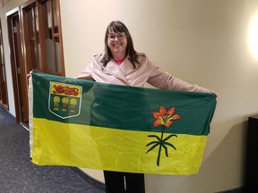 Gail Hapanowicz holds the Saskatchewan flag, which turns 50 years old this year. Hapanowicz and her husband are organizing several events celebrating the flag's anniversary. Photo courtesy Gail Hapanowicz