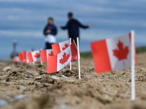 This illustration picture taken on June 4, 2019 shows Canadian flags planted in the sand of Juno Beach in Courseulles-sur-Mer, western France, during the preparations of the celebrations marking the 75th anniversary of D-Day landings.