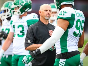 Saskatchewan Roughriders head coach Craig Dickenson chats with players in warmup before facing the Calgary Stampeders during CFL pre-season football in Calgary on Friday, May 31, 2019. Al Charest/Postmedia ORG XMIT: POS1905312007171064