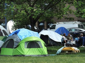 VANCOUVER, BC., June 12, 2019 - Campers at Oppenheimer Park as Mayor Kennedy Stewart provides a briefing following the release of 2019's Vancouver Homeless Count numbers in Vancouver,  BC., June 12, 2019.  (NICK PROCAYLO/PostMedia)   00057749A ORG XMIT: 00057749A [PNG Merlin Archive]