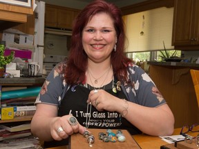 Jewelry artist Laura Steadman displays some of the memory beads she made out of glass and the ash of a deceased loved one.
