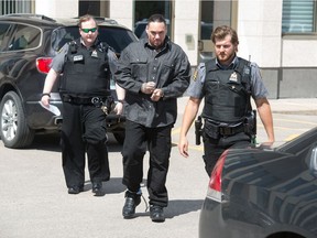 Steven Paul St. Pierre, centre, leaves Regina's Court of Queen's Bench after pleading guilty to manslaughter in the 2017 homicide of Blaine Katz.