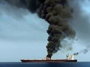 A picture obtained by AFP from Iranian State TV IRIB on June 13 reportedly shows smoke billowing from a tanker said to have been attacked off the coast of Oman.
