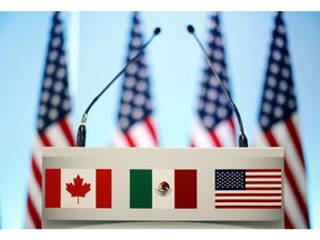 FILE PHOTO: The flags of Canada, Mexico and the U.S. on a lectern before a joint news conference on the closing of the seventh round of NAFTA talks in Mexico City, Mexico March 5, 2018. REUTERS/Edgard Garrido/File Photo