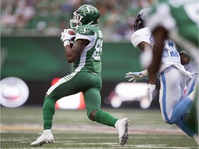 Kyran Moore #85 of the Saskatchewan Roughriders takes a pass in for a 98-yard touchdown against the Toronto Argonauts at Mosaic Stadium on Monday.