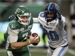 Cody Fajardo #7 of the Saskatchewan Roughriders outruns a Toronto Argonauts defender at Mosaic Stadium.