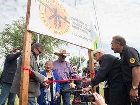 George Gordon First Nation residents Henry Bird, 96 (second from right) and Nancy Bitternose, 98 (third from left) cut a ribbon at an event to mark the First Nation's purchase of 579 acres of land near the Wascana Country Club.