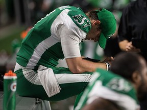 A dejected Cody Fajardo sits on the Saskatchewan Roughriders' bench after throwing an interception during Saturday's 37-10 loss to the visiting Calgary Stampeders.