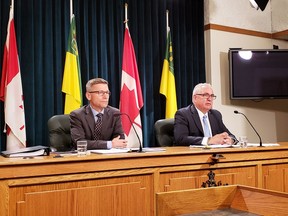 SGI CFO Jeff Stepan (left) and Minister responsible for SGI Joe Hargrave discuss the Crown corporation's 2018-19 annual report in Regina Tuesday. Photo by Ethan Williams