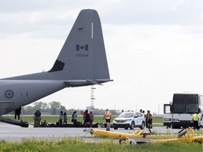 A Canadian Forces CC-130J Hercules carried residents from the Pikangikum First Nations, in Ontario, to the Regina International Airport in Regina.