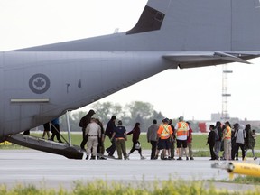 A Canadian Forces CC-130J Hercules carried residents from the Pikangikum First Nations, in Ontario, to the Regina International Airport in Regina on Thursday afternoon.
