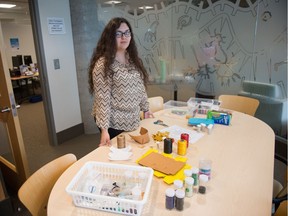 Poetry Doehl, a summer student working at the Aboriginal Student Centre at the University of Regina, stands at a table with art supplies, which are meant to be used by Ontario wildfire evacuees to create beadwork and birch bark baskets.
