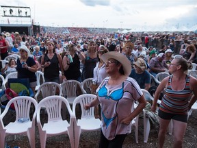 Fans dance and look on while country singer Travis Tritt performs during the Country Thunder music festival on Saturday.