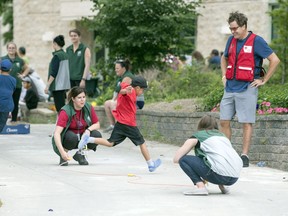 Evacuees play outside with volunteers at the University of Regina.