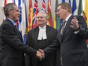 REGINA, SASK :  July 18, 2019  --    Saskatchewan Premier Scott Moe, right, congratulates Russell B. Mirasty, left, after officially being sworn in by Chief Justice of Saskatchewan Robert Richards, middle, as Saskatchewan's 23rd Lieutenant Governor at a ceremony held at Government House in Regina. TROY FLEECE / Regina Leader-Post