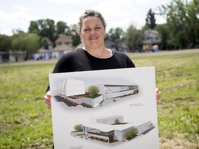 In a file photo from July 2019, YWCA CEO Melissa Coomber-Bendtsen holds up drawings in Lucy Eley Park, future home of the YWCA, of what the new building would look like if built in Regina.