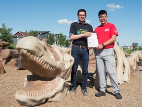 Adam Hicks, board chair of Summer Bash, stands with Justin Duong, volunteer co-ordinator, together holding a red light ticket in Fairchild Park. Summer Bash festival is partnering with the province's Fine Options program, where people can pay off traffic violations by volunteering for the event.